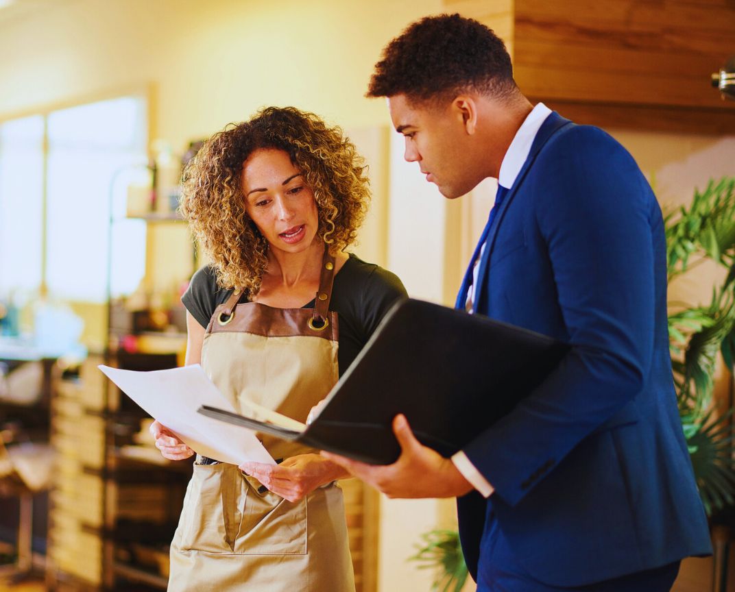 Financial Adviser South East Melbourne – discussing asset protection strategies in the office