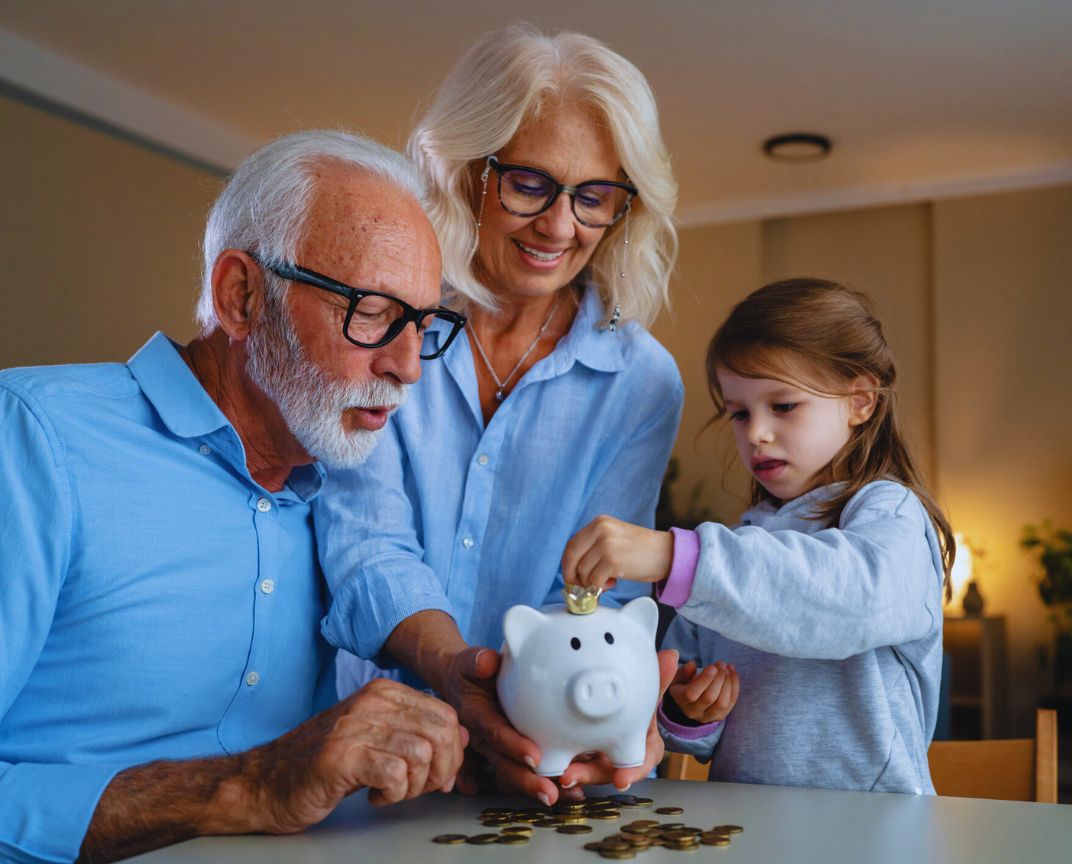 Financial Adviser South East Melbourne – grandparents teaching kids to save with a piggybank