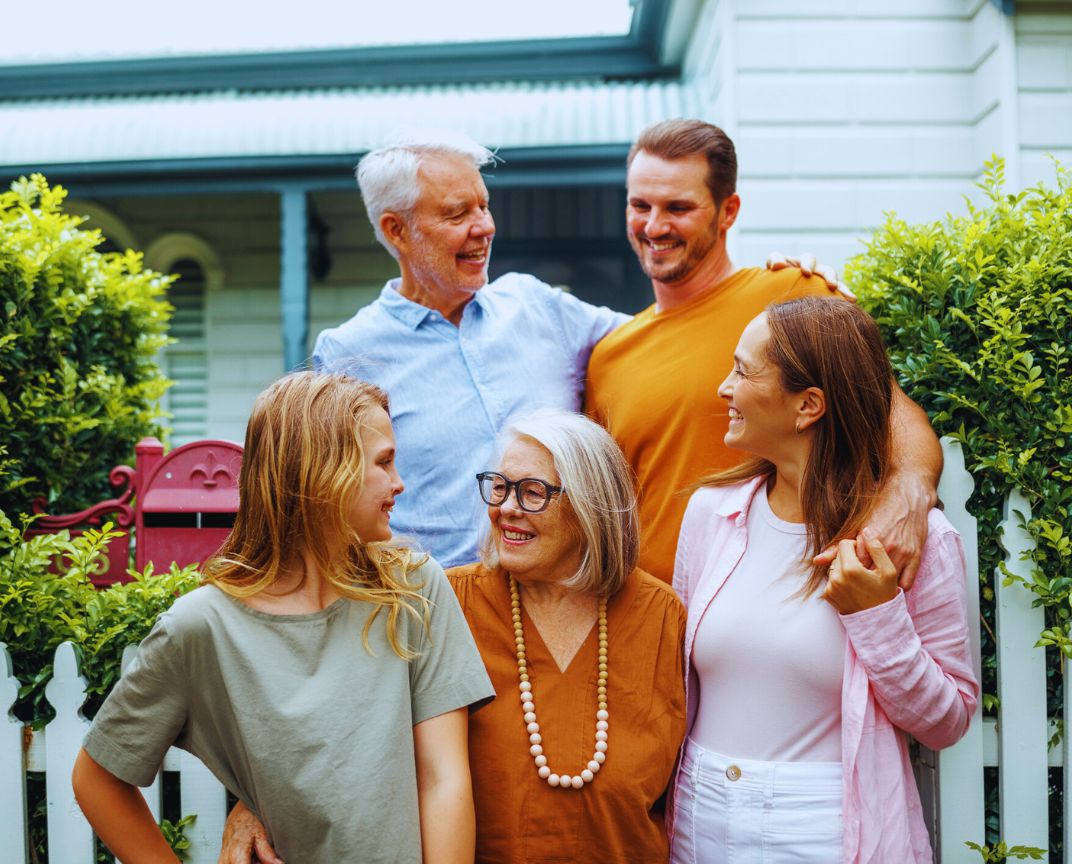 Financial Adviser South East Melbourne – happy family standing together outside their home
