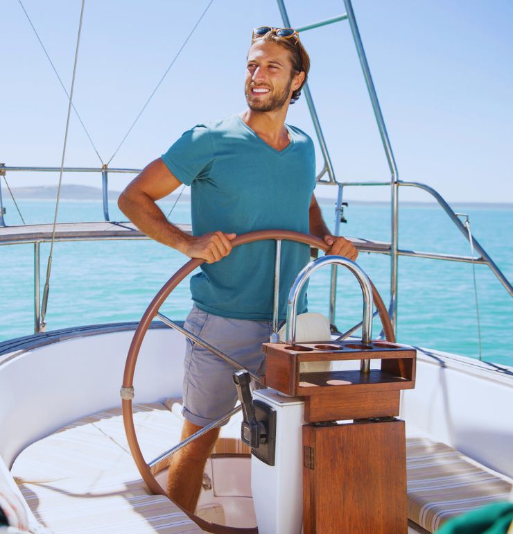 Financial Adviser South East Melbourne – man at the helm of a yacht