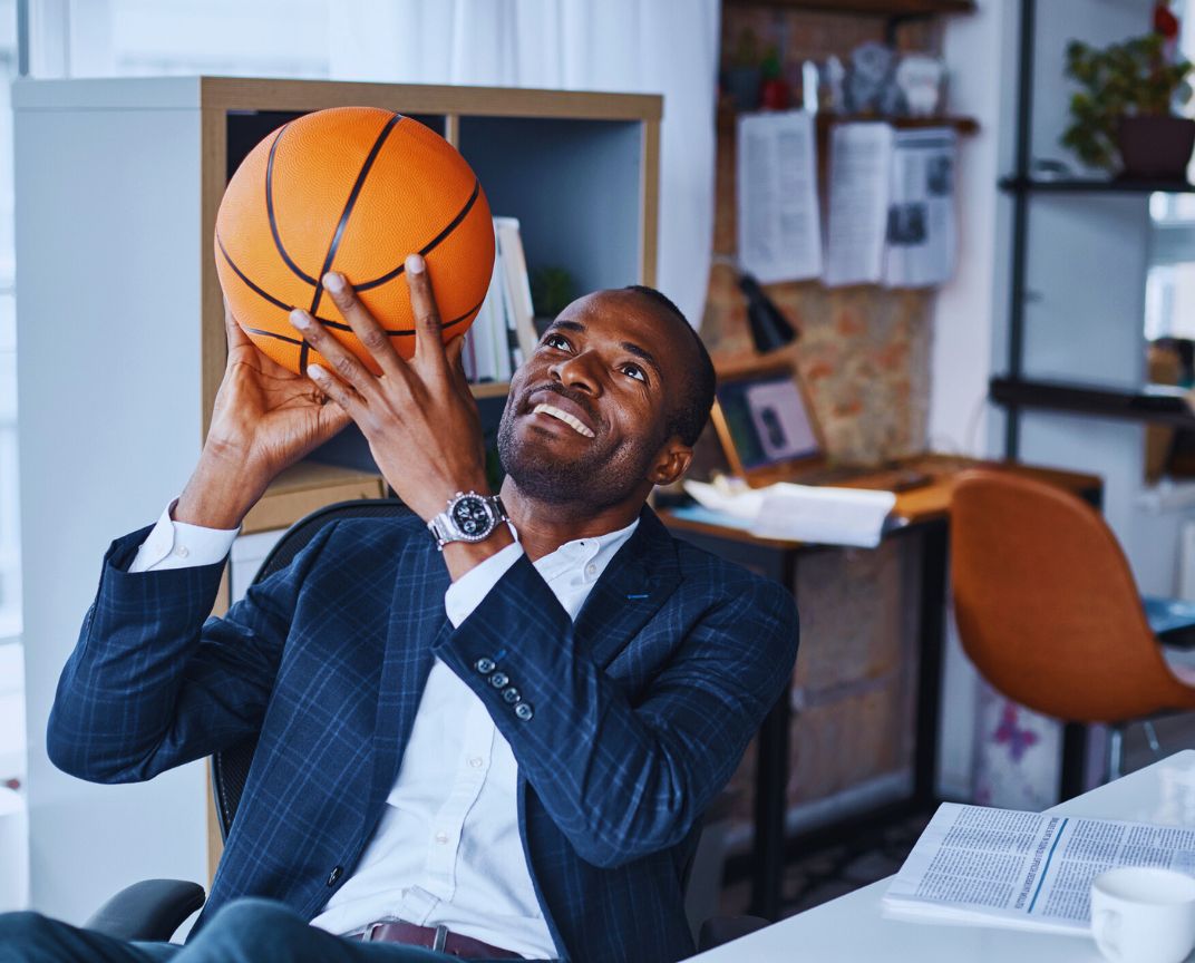 Financial Adviser South East Melbourne – man holding a ball in the office