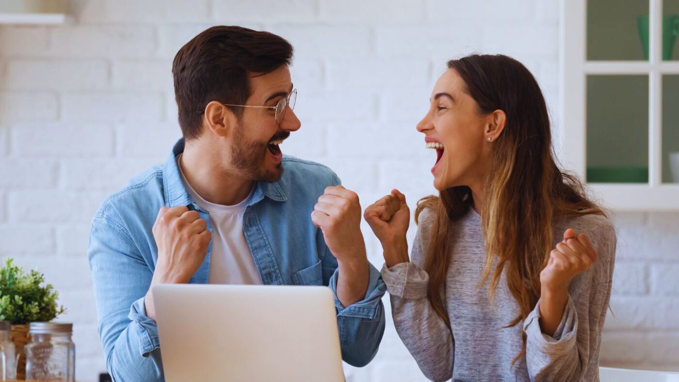 Financial Adviser South East Melbourne – young couple celebrating exciting financial news